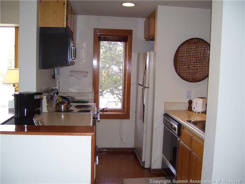 22340 Highway 6, Unit 1815 Keystone, CO 80435 - Photo 7 of 12 a kitchen with sink and cabinets