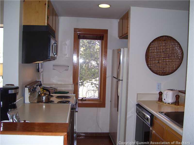 22340 Highway 6, Unit 1815 Keystone, CO 80435 - Photo 8 of 12 a kitchen with a sink cabinets and a window