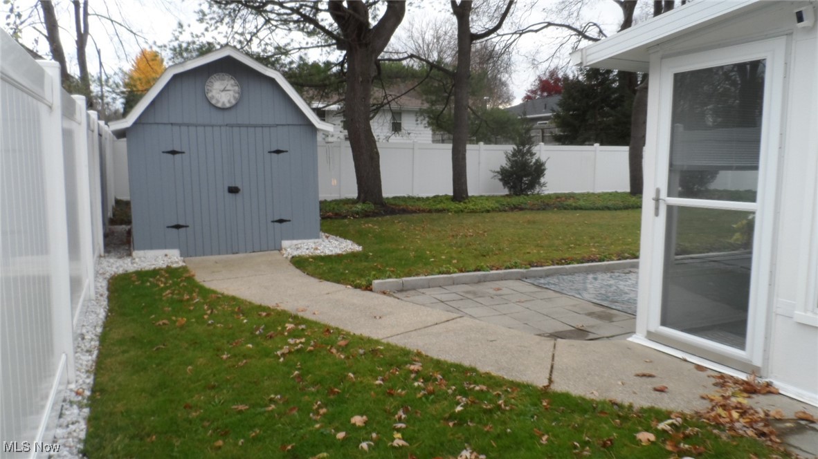 2542 Carson Road Fairlawn, OH 44333 - Photo 25 of 28 View of yard featuring a storage unit and a patio area