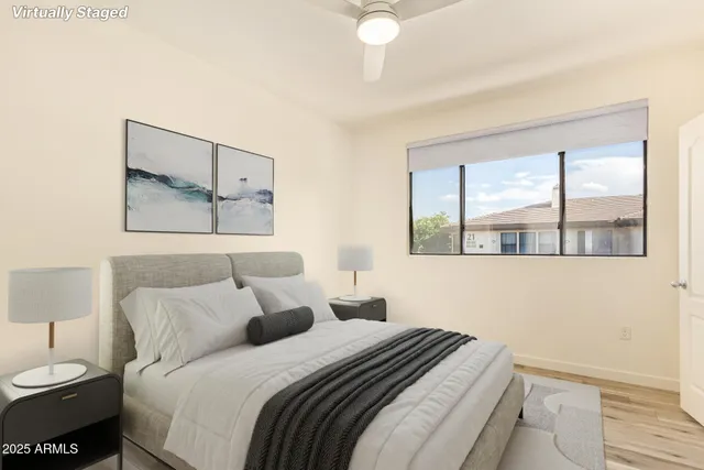 a bedroom with a bed and a large window