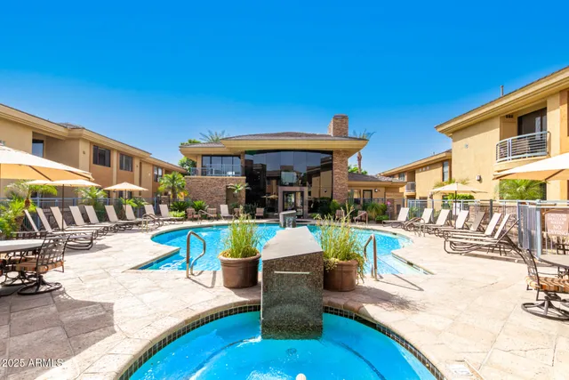 outdoor view of a swimming pool with outdoor seating