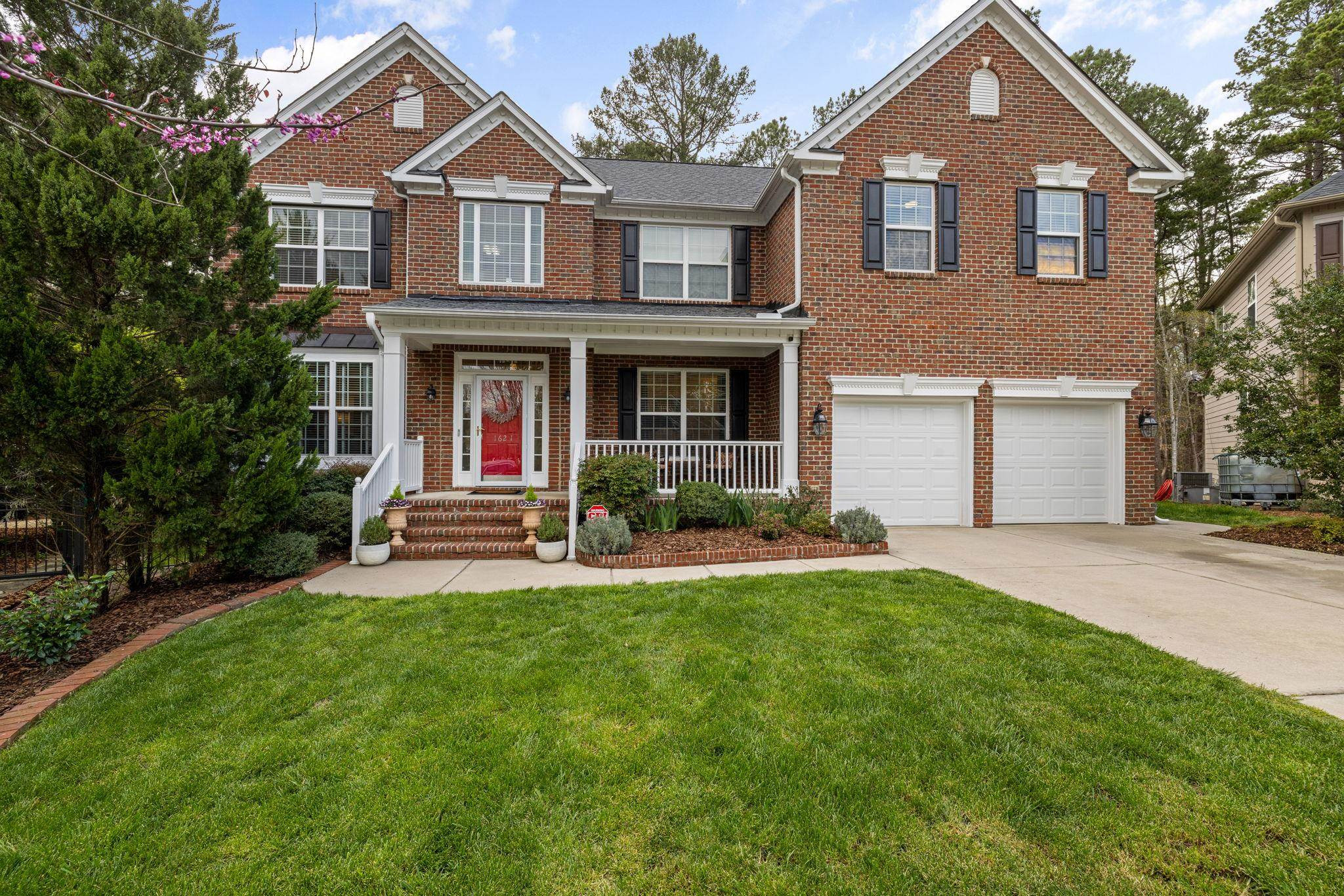 a front view of a house with a yard and garage