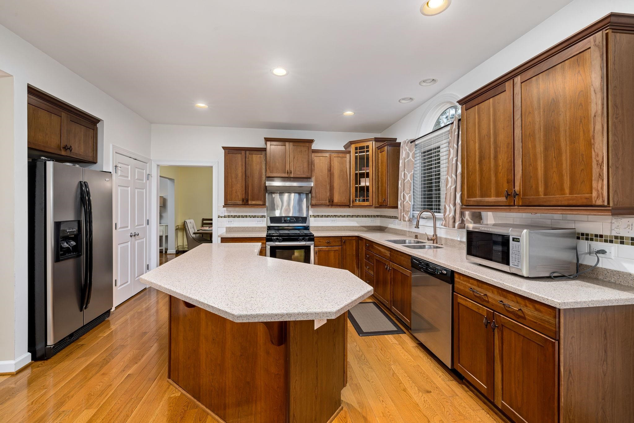 1621 Timber Wolf Drive Durham, NC 27713 - Photo 19 of 48 a kitchen with stainless steel appliances granite countertop a sink stove refrigerator and cabinets