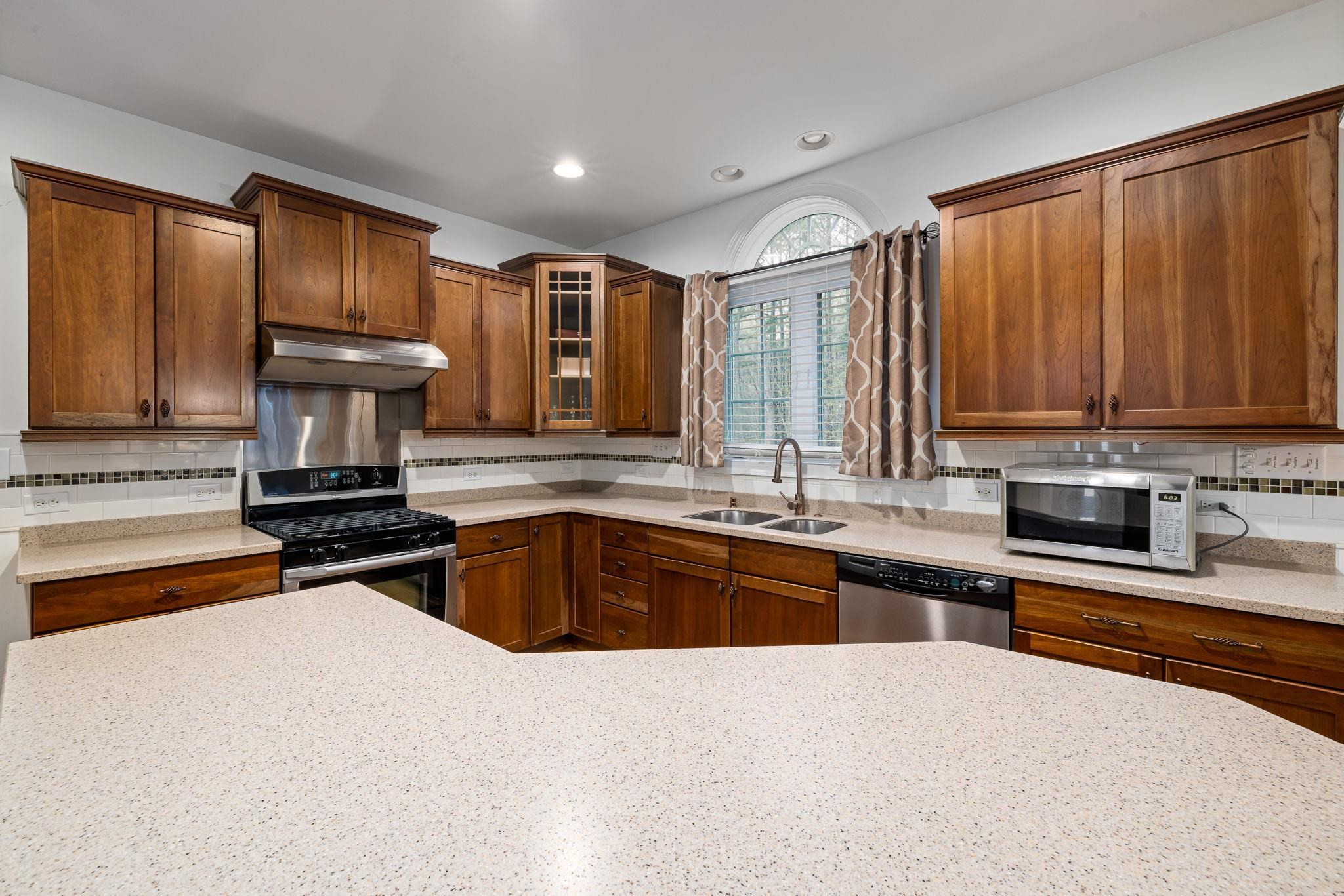 1621 Timber Wolf Drive Durham, NC 27713 - Photo 20 of 48 a kitchen with stainless steel appliances granite countertop a stove sink and cabinets