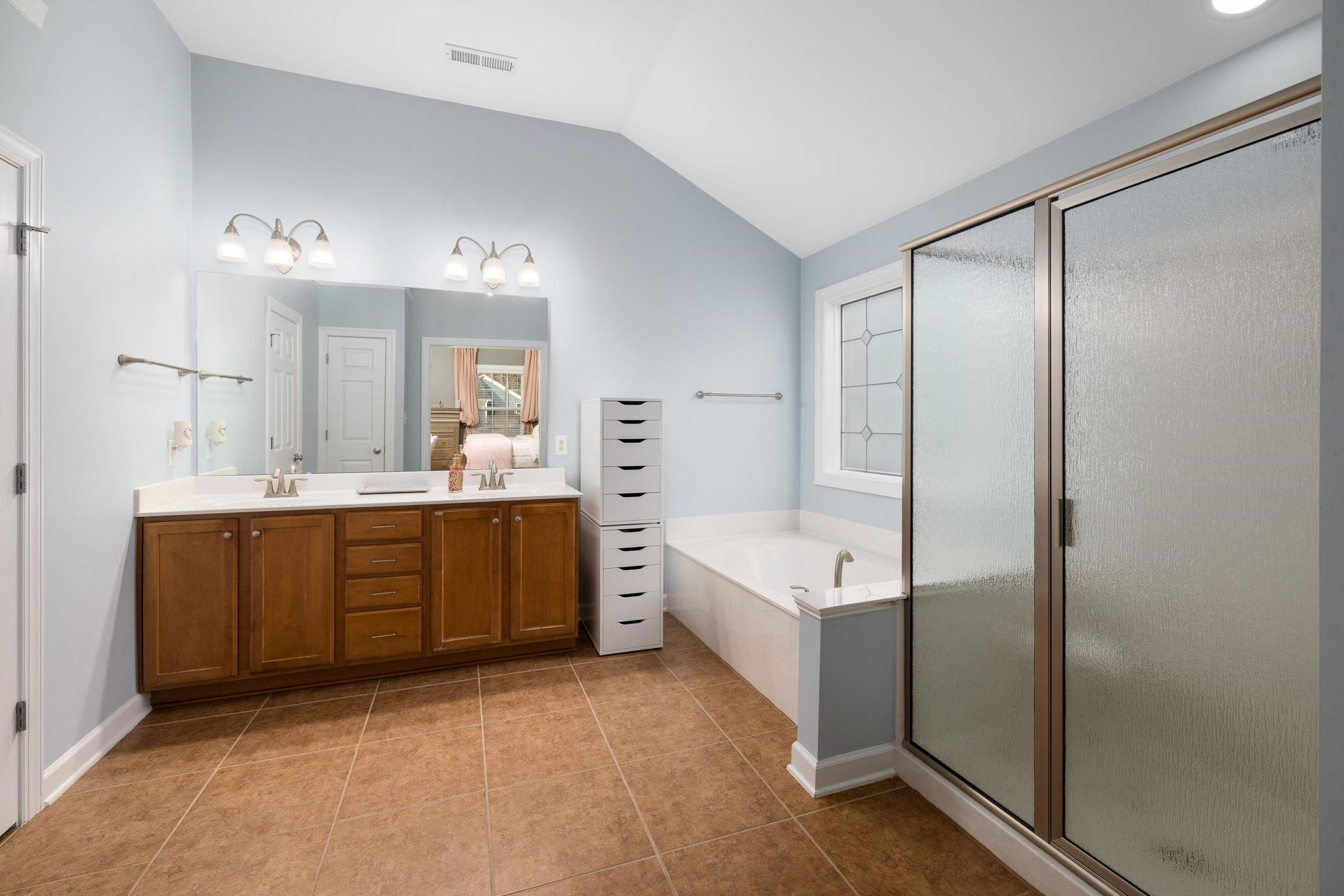 1621 Timber Wolf Drive Durham, NC 27713 - Photo 40 of 48 a bathroom with a tub a sink shower and mirror