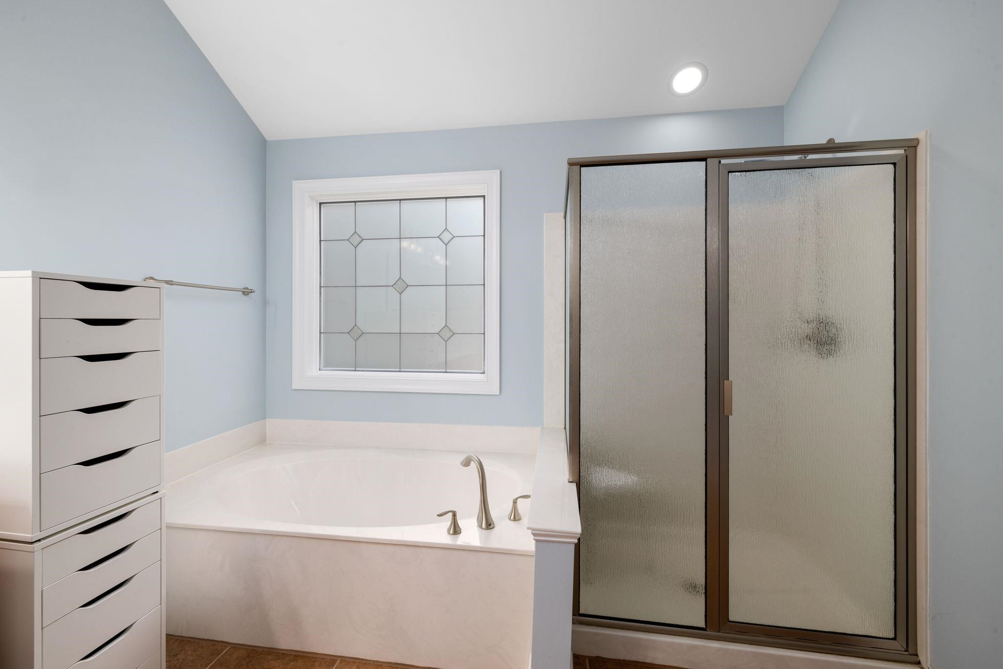 1621 Timber Wolf Drive Durham, NC 27713 - Photo 41 of 48 a bathroom with a bathtub and a shower