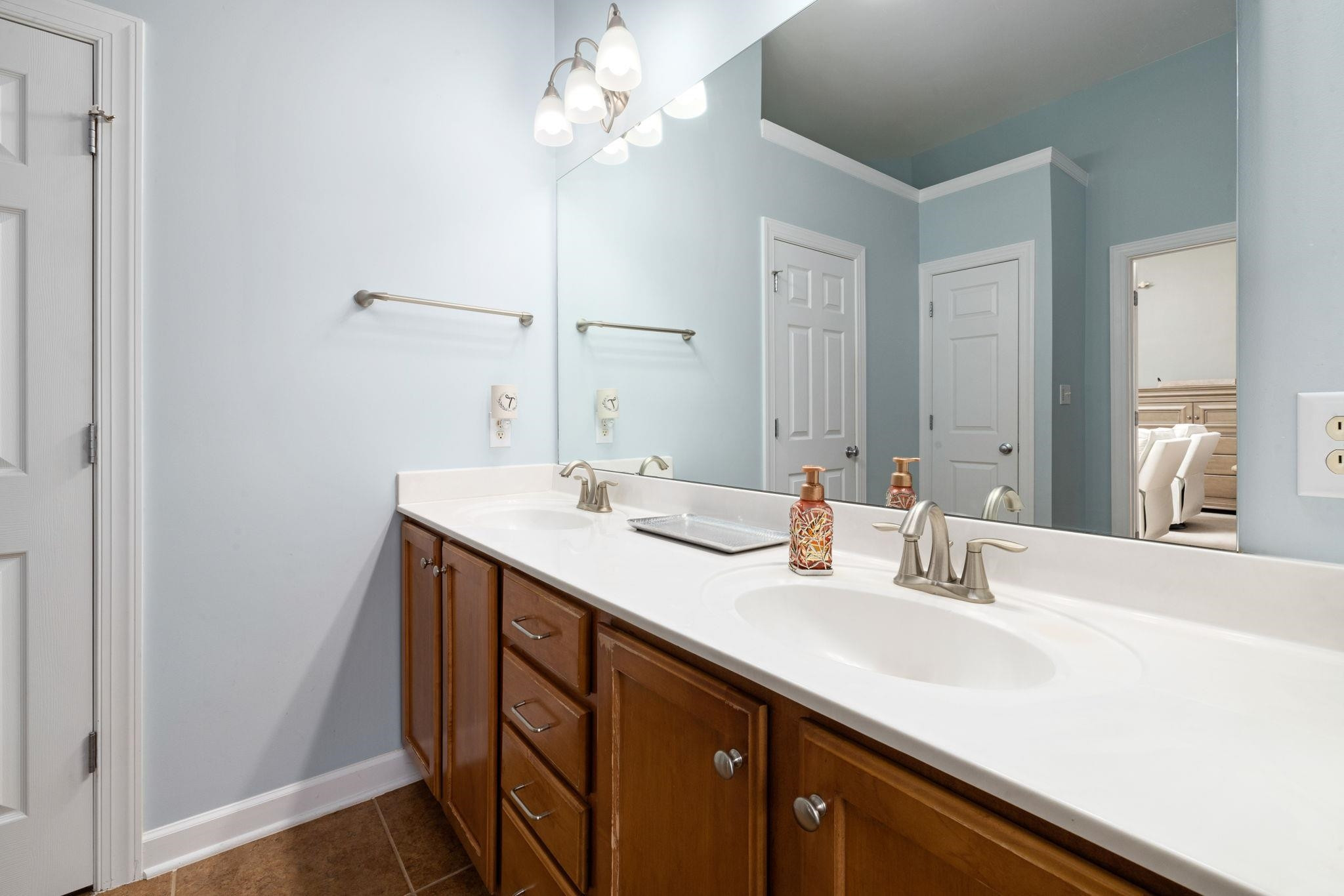 1621 Timber Wolf Drive Durham, NC 27713 - Photo 42 of 48 a bathroom with a sink a mirror and a shower