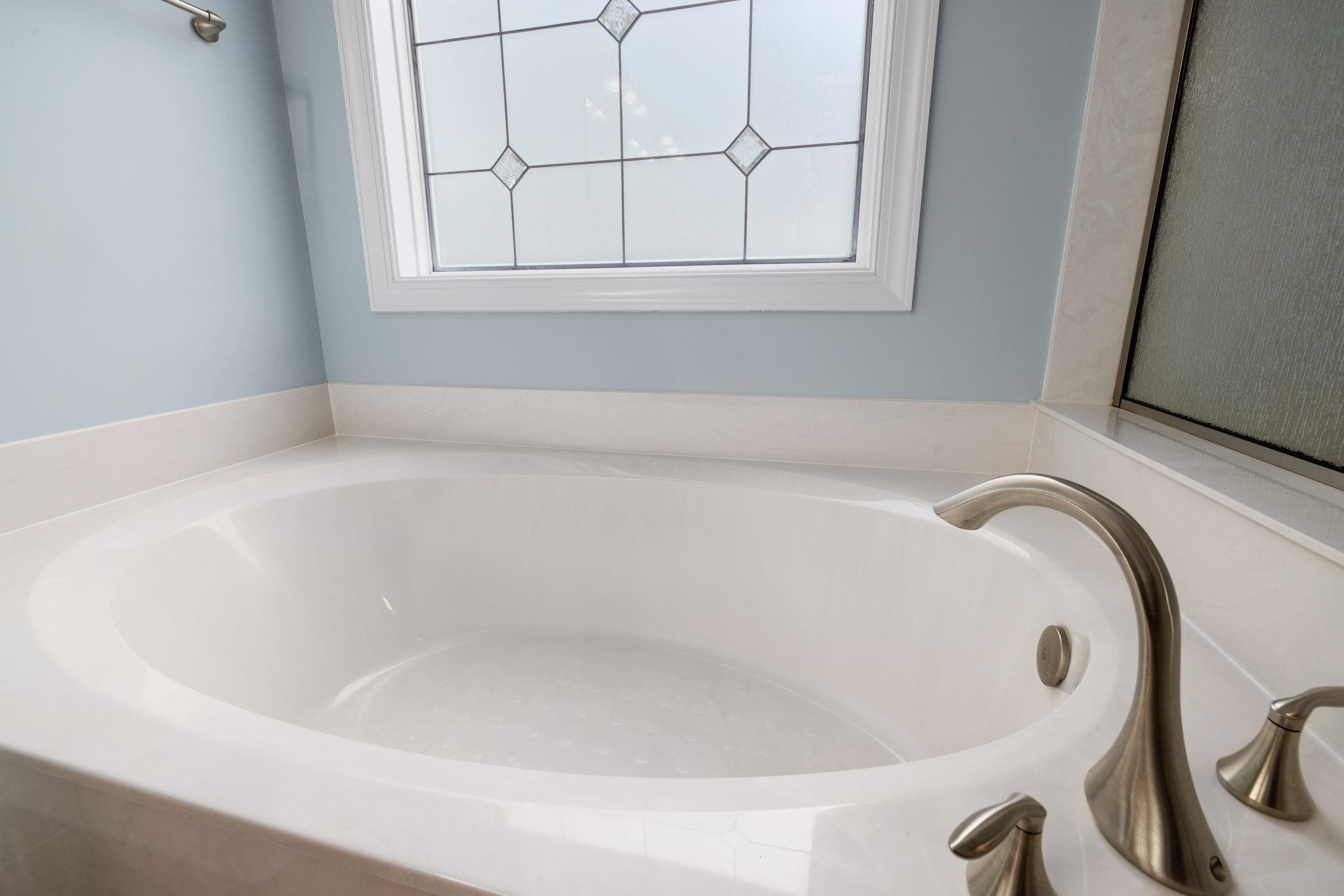 1621 Timber Wolf Drive Durham, NC 27713 - Photo 43 of 48 a white bath tub sitting in a bathroom
