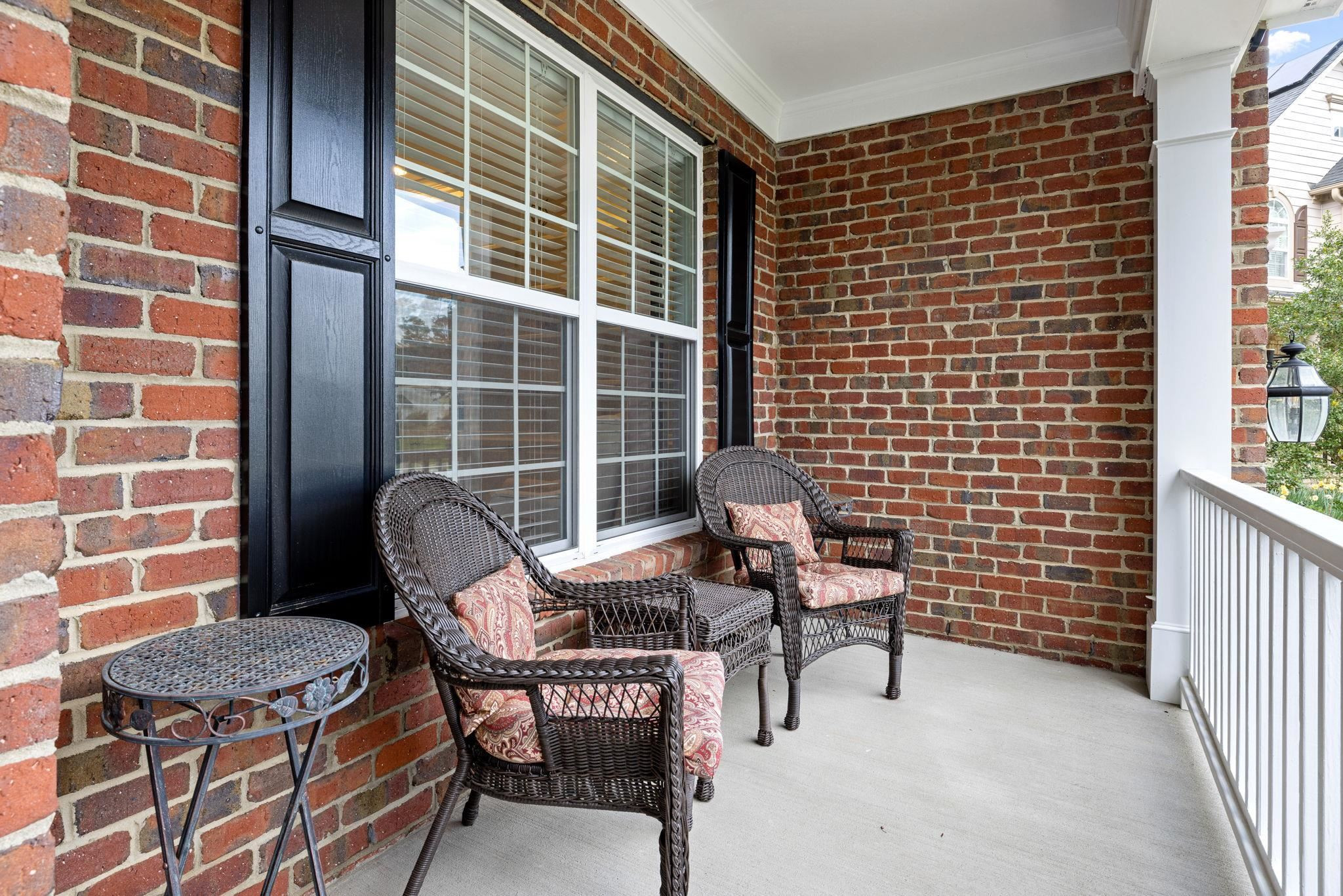 1621 Timber Wolf Drive Durham, NC 27713 - Photo 9 of 48 a balcony with a couch and a potted plant