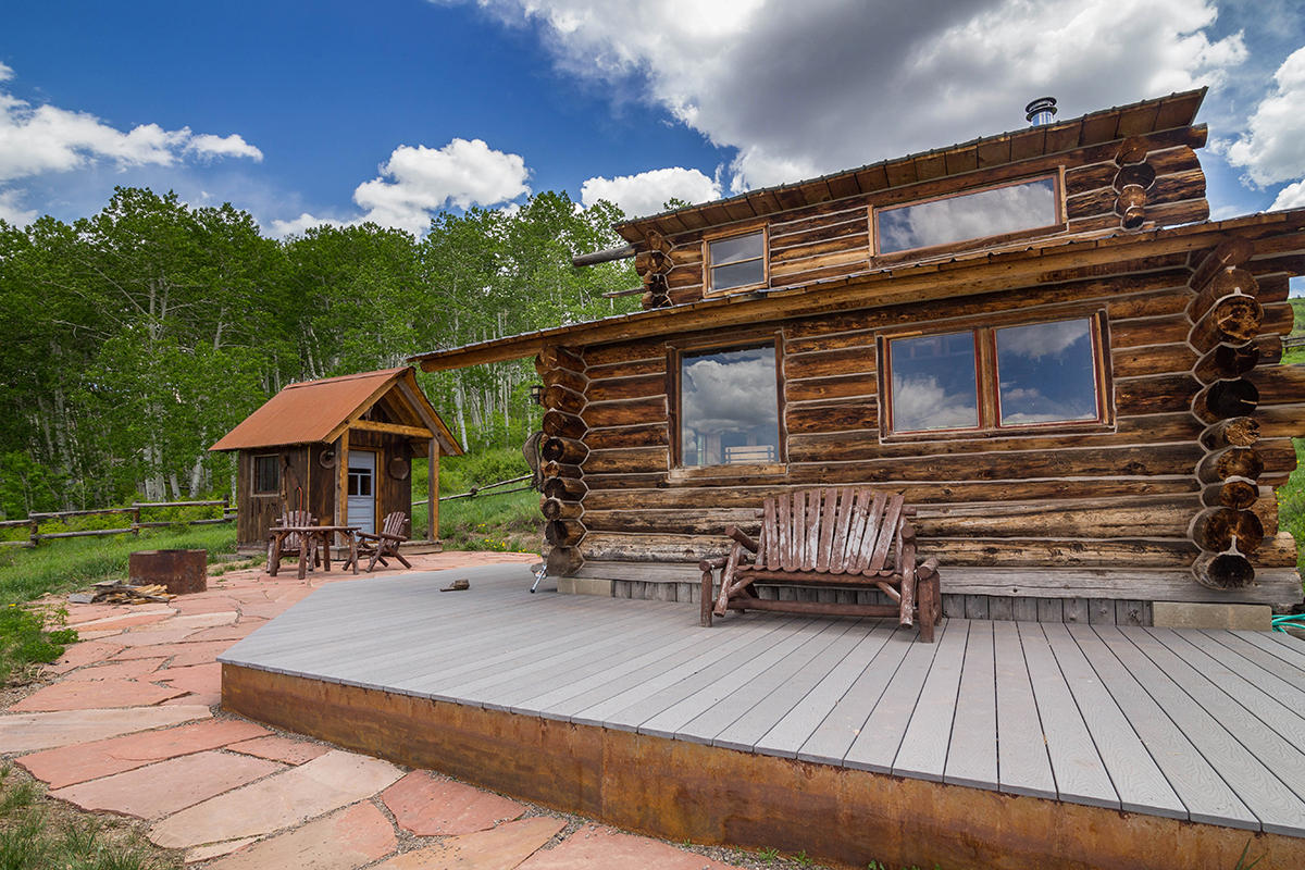 3520 County 58P Road Placerville, CO 81430 - Photo 15 of 76 a backyard of a house with table and chairs