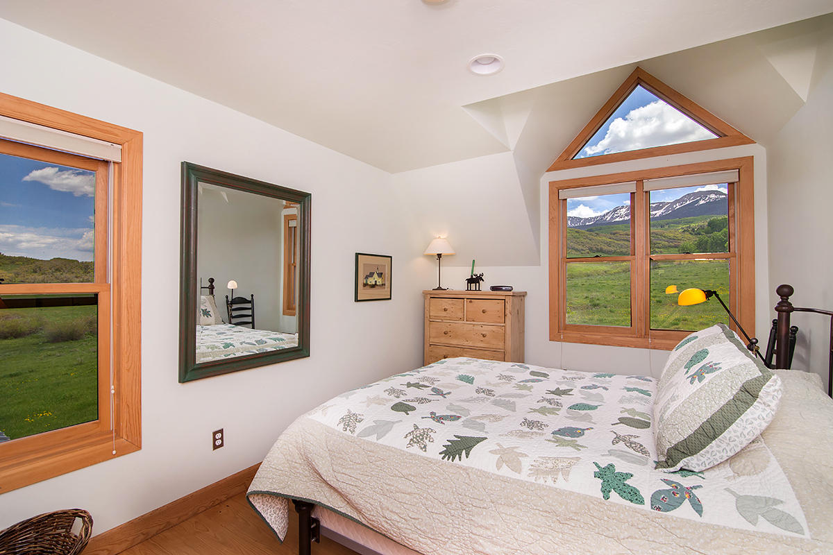 3520 County 58P Road Placerville, CO 81430 - Photo 39 of 76 a bed sitting in a bedroom next to a window