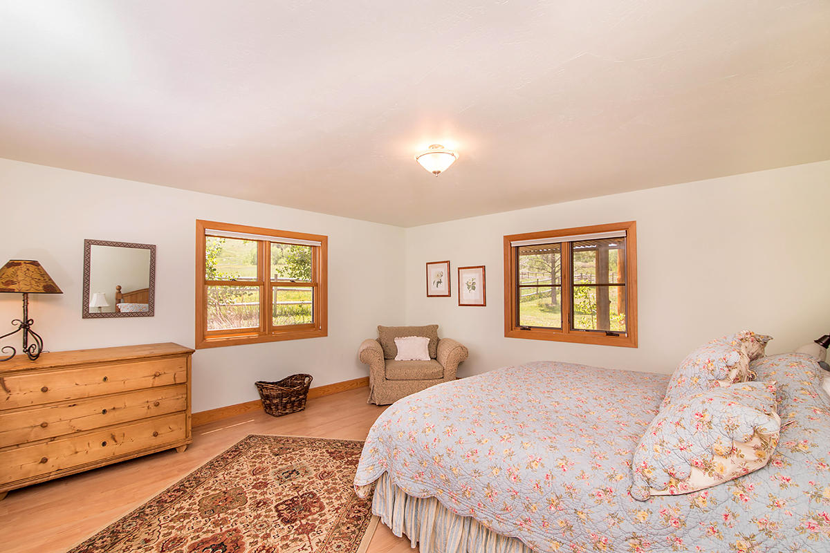 3520 County 58P Road Placerville, CO 81430 - Photo 42 of 76 a bedroom with a bed and wooden floor