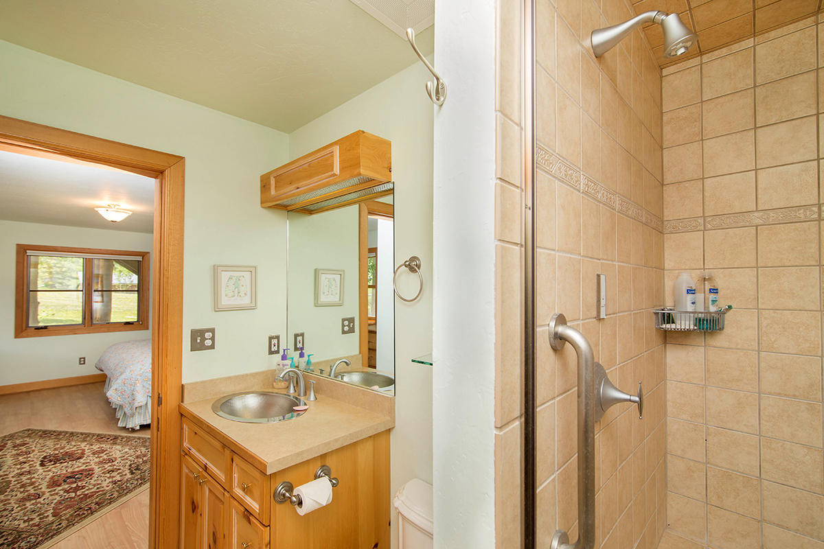 3520 County 58P Road Placerville, CO 81430 - Photo 43 of 76 a bathroom with a granite countertop sink a mirror and a shower