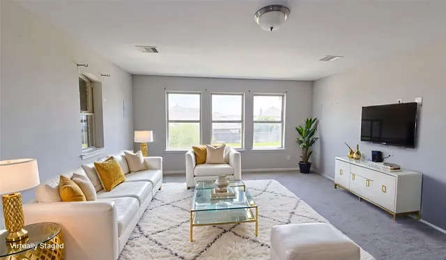 a living room with furniture and a flat screen tv