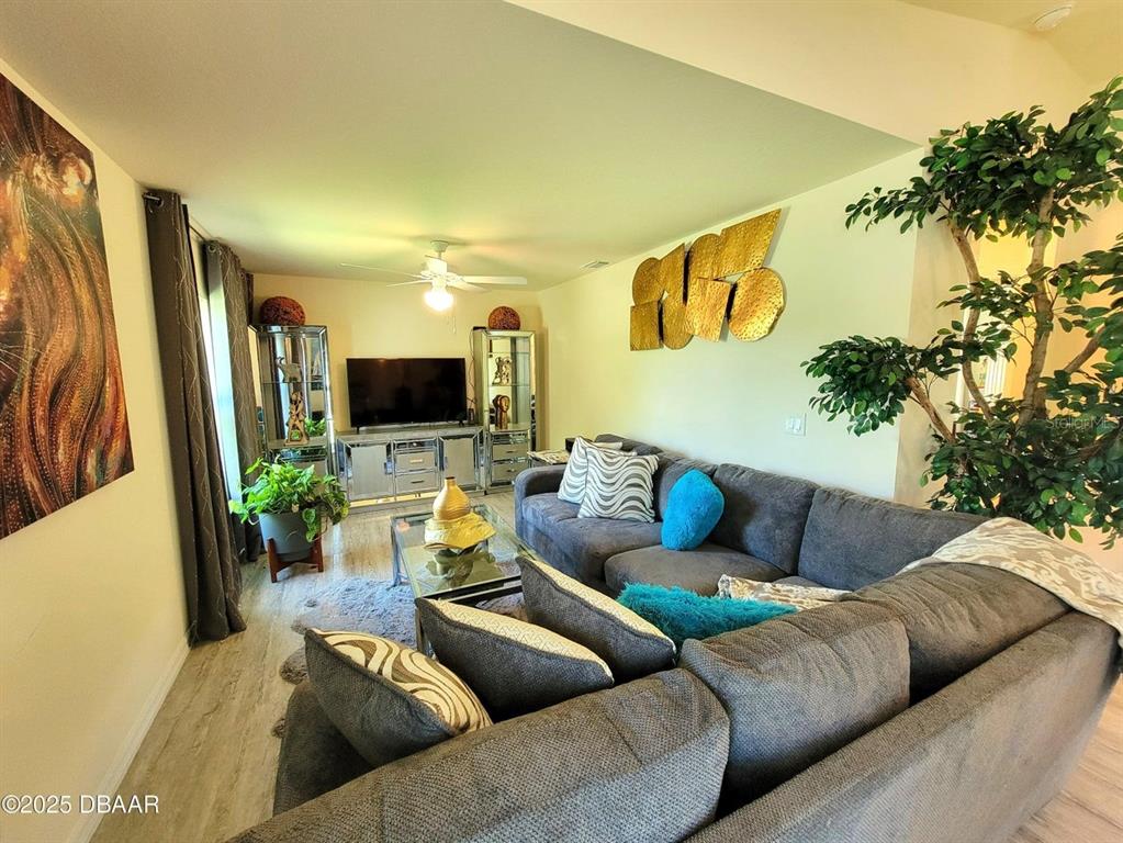 5023 Littlefield Road LaBelle, FL 33935 - Photo 12 of 36 a living room with furniture and a flat screen tv