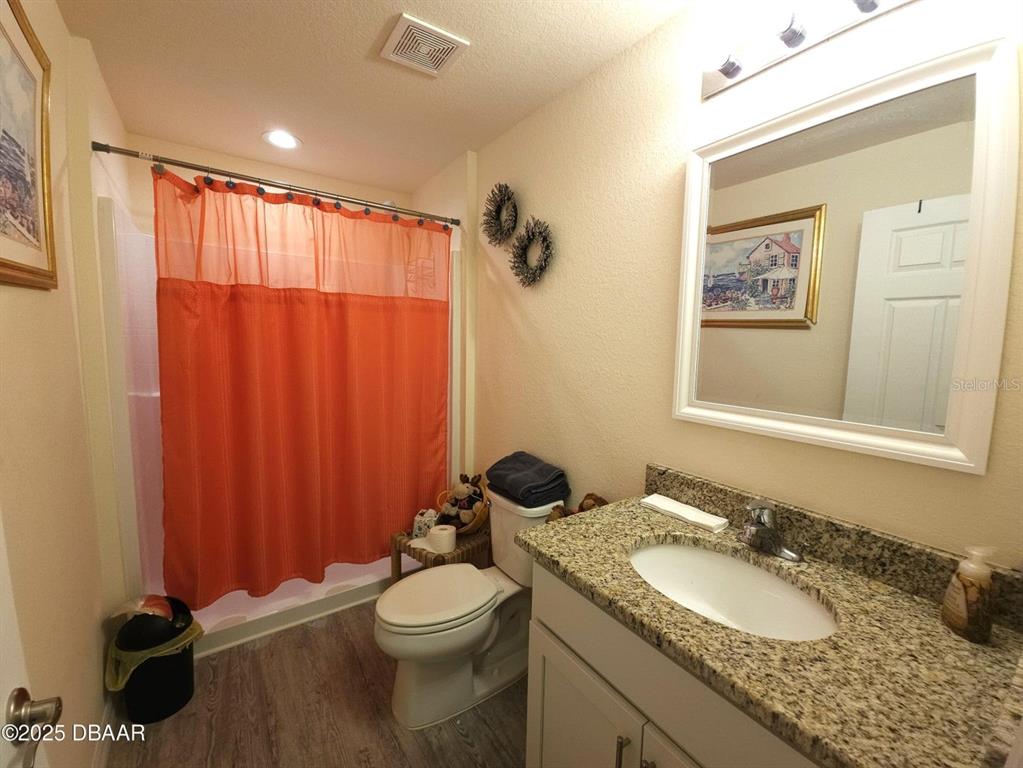 5023 Littlefield Road LaBelle, FL 33935 - Photo 22 of 36 a bathroom with a granite countertop sink mirror vanity and toilet