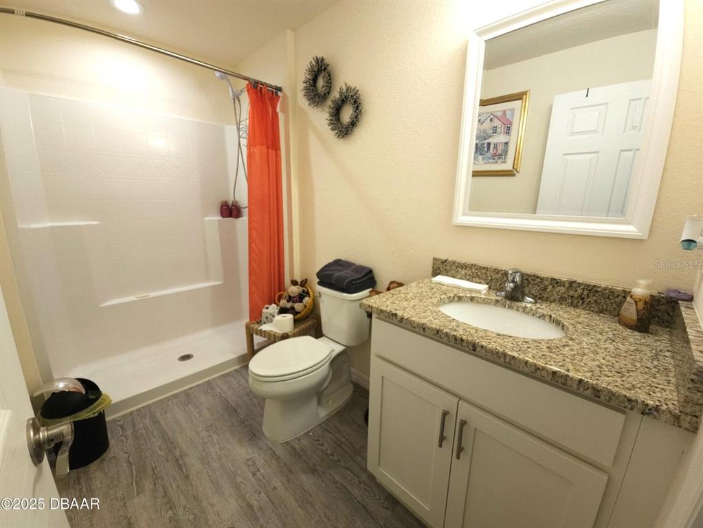 5023 Littlefield Road LaBelle, FL 33935 - Photo 23 of 36 a bathroom with a granite countertop sink toilet and shower
