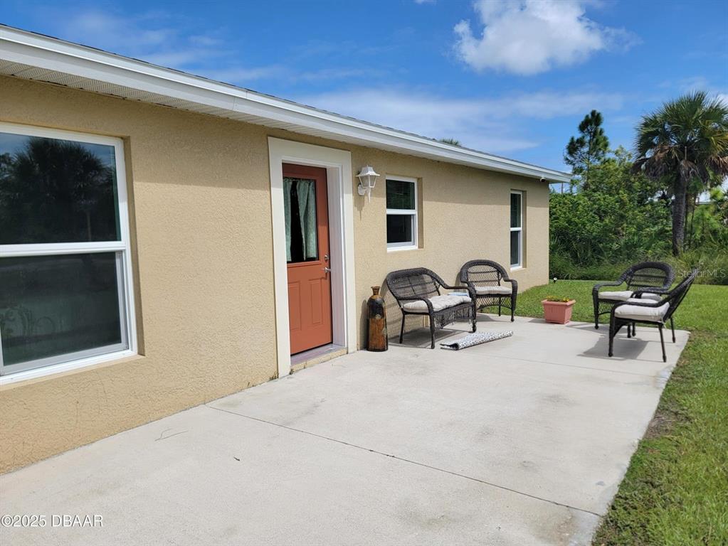 5023 Littlefield Road LaBelle, FL 33935 - Photo 25 of 36 a view of a patio with table and chairs and potted plants