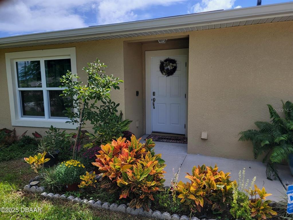 5023 Littlefield Road LaBelle, FL 33935 - Photo 4 of 36 a front view of a house with a yard and flowers