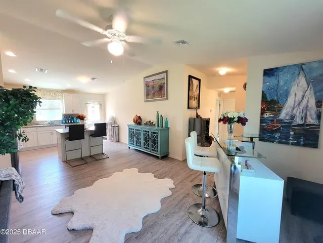a living room with furniture and kitchen view