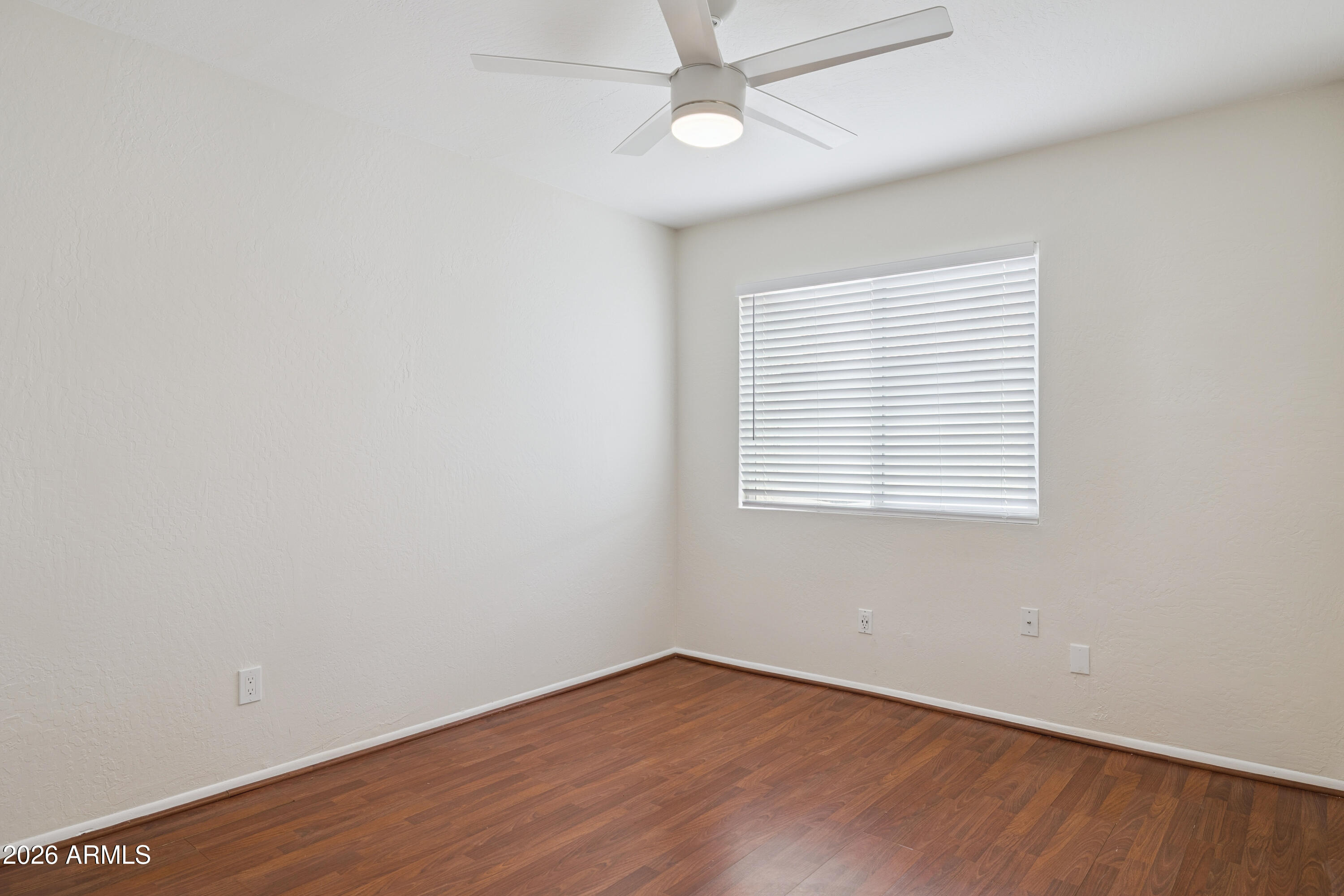 4343 East Osborn Road Phoenix, AZ 85018 - Photo 16 of 41 an empty room with wooden floor and windows