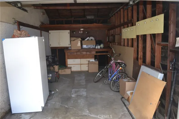 a view of storage and utility room with two washing machine