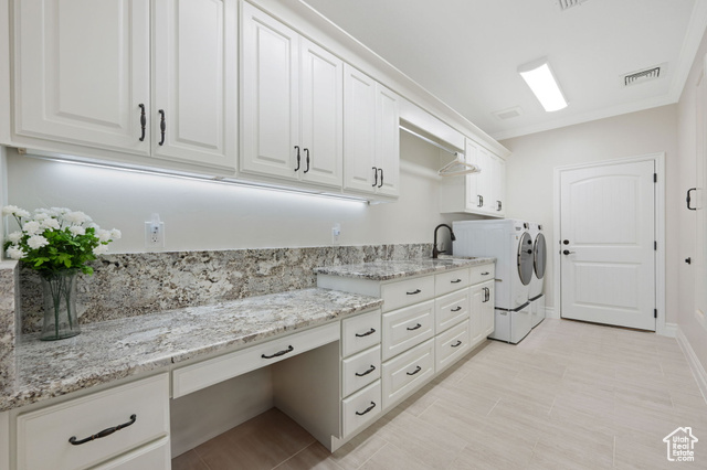 230 Boulder Way Leeds, UT 84746 - Photo 28 of 72 Main Laundry room with granite countertops, soft-close cabinetry, cabinet space, and ornamental molding with built-in ironing board and entrance to garage.