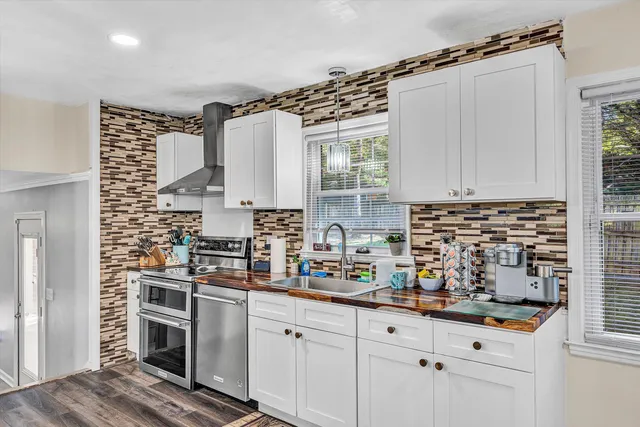 a kitchen with a stove a sink and a refrigerator