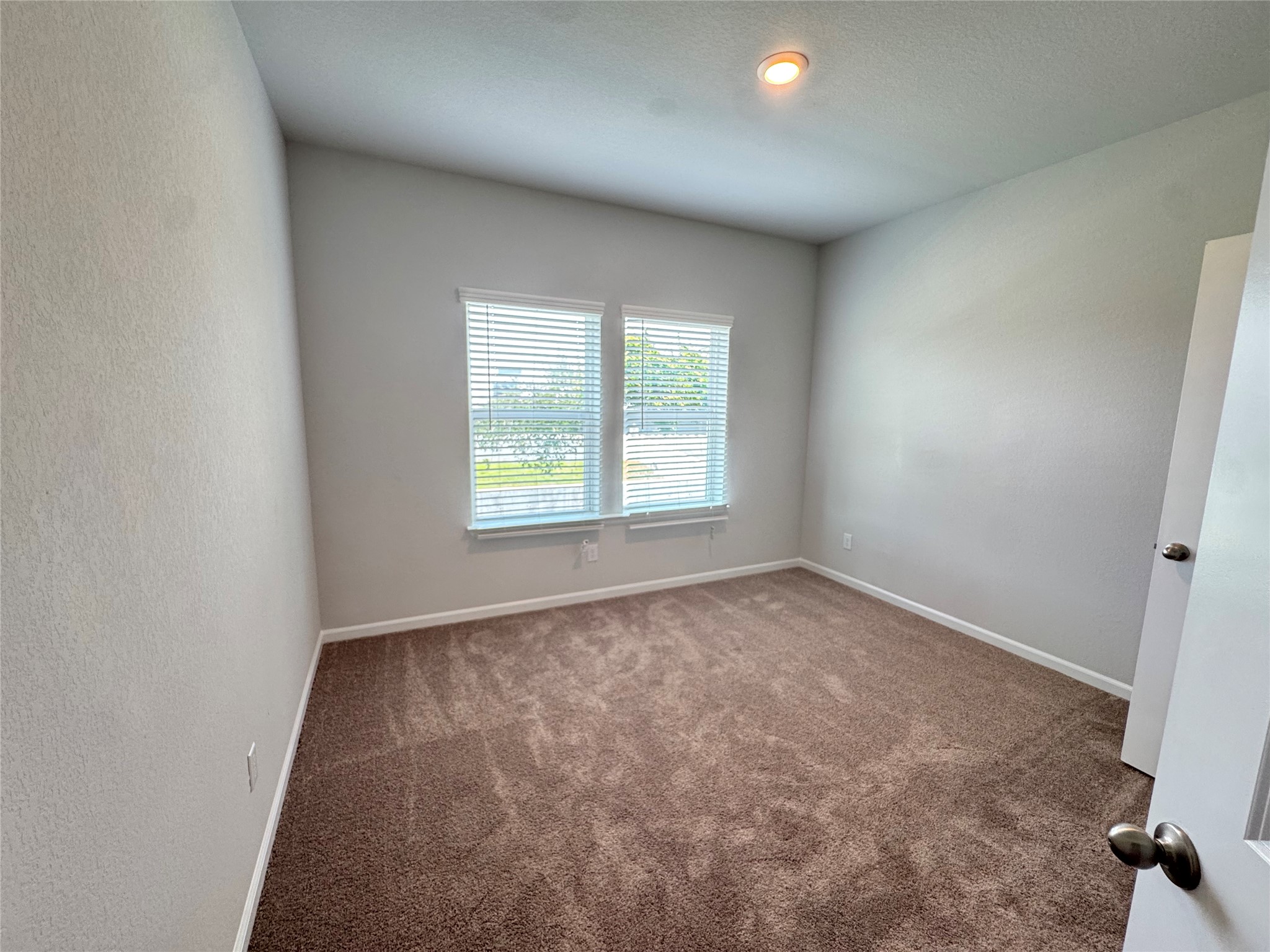 3000 Chisholm Trail Road, Unit 41 Round Rock, TX 78681 - Photo 21 of 28 A well-lit bedroom offering a blank canvas for personalization, complete with soft carpet and natural light.