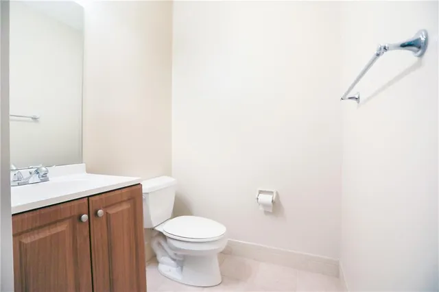 a bathroom with a toilet a sink and mirror