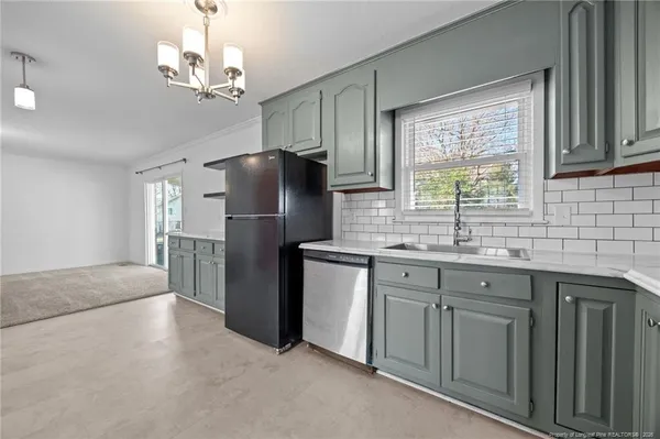 a kitchen with kitchen island granite countertop stainless steel appliances cabinets a sink and a counter top space