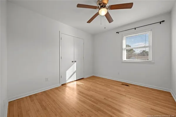 a view of walk in closet with wooden floor