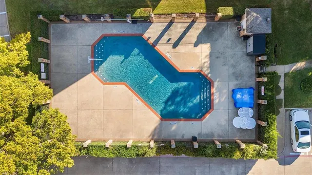 an aerial view of a house with a yard and large trees