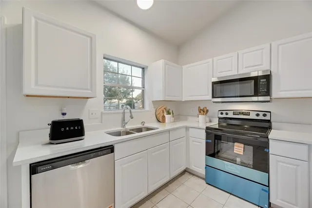 a kitchen with a sink stove and microwave