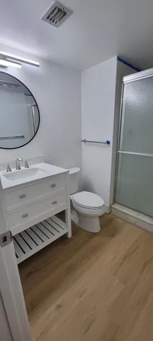 a view of a room with wooden floor and window