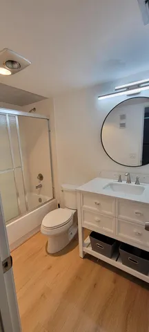 a bathroom with a sink a toilet and a mirror