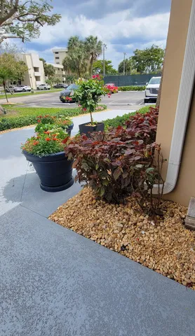 a view of swimming pool with outdoor seating and plants