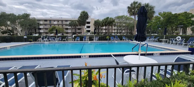a view of a swimming pool with chairs