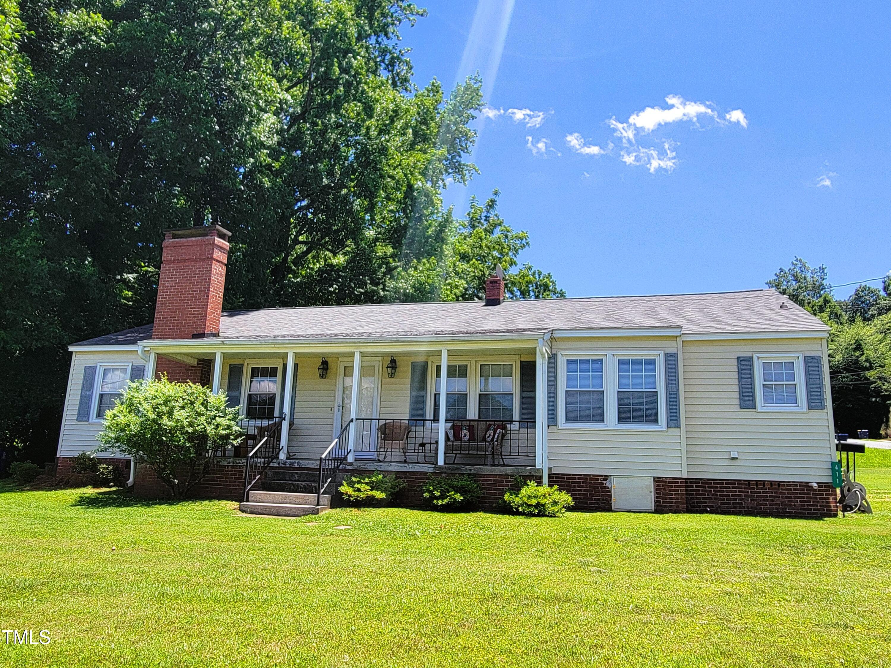411 West Raleigh Street Siler City, NC 27344 - Photo 1 of 33 a view of a house with swimming pool and a yard