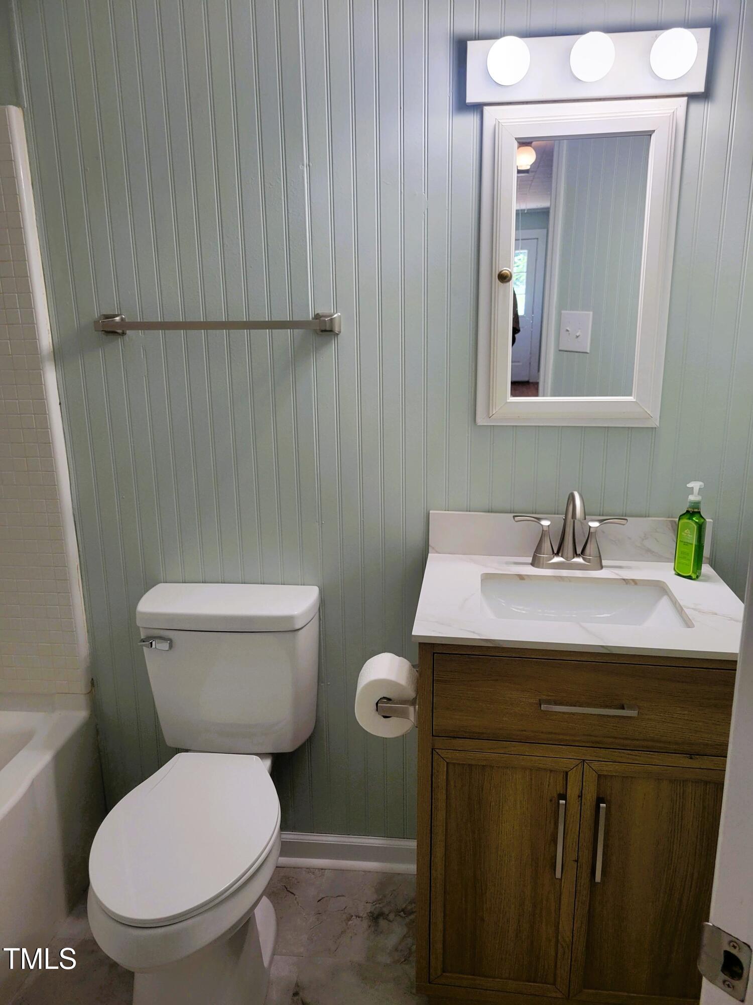 411 West Raleigh Street Siler City, NC 27344 - Photo 12 of 33 a bathroom with a sink a toilet and mirror
