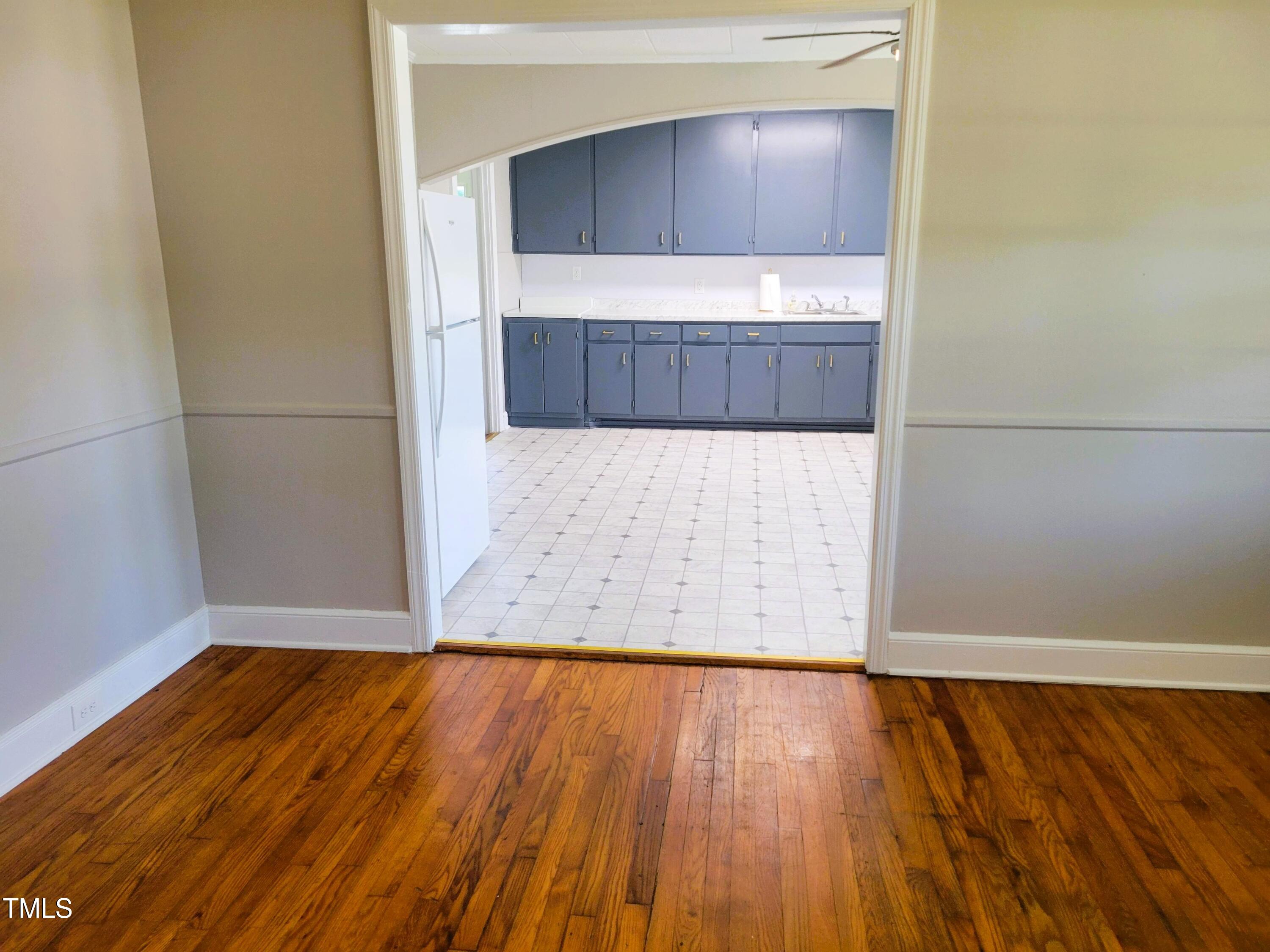411 West Raleigh Street Siler City, NC 27344 - Photo 19 of 33 an empty room with wooden floor and cabinet