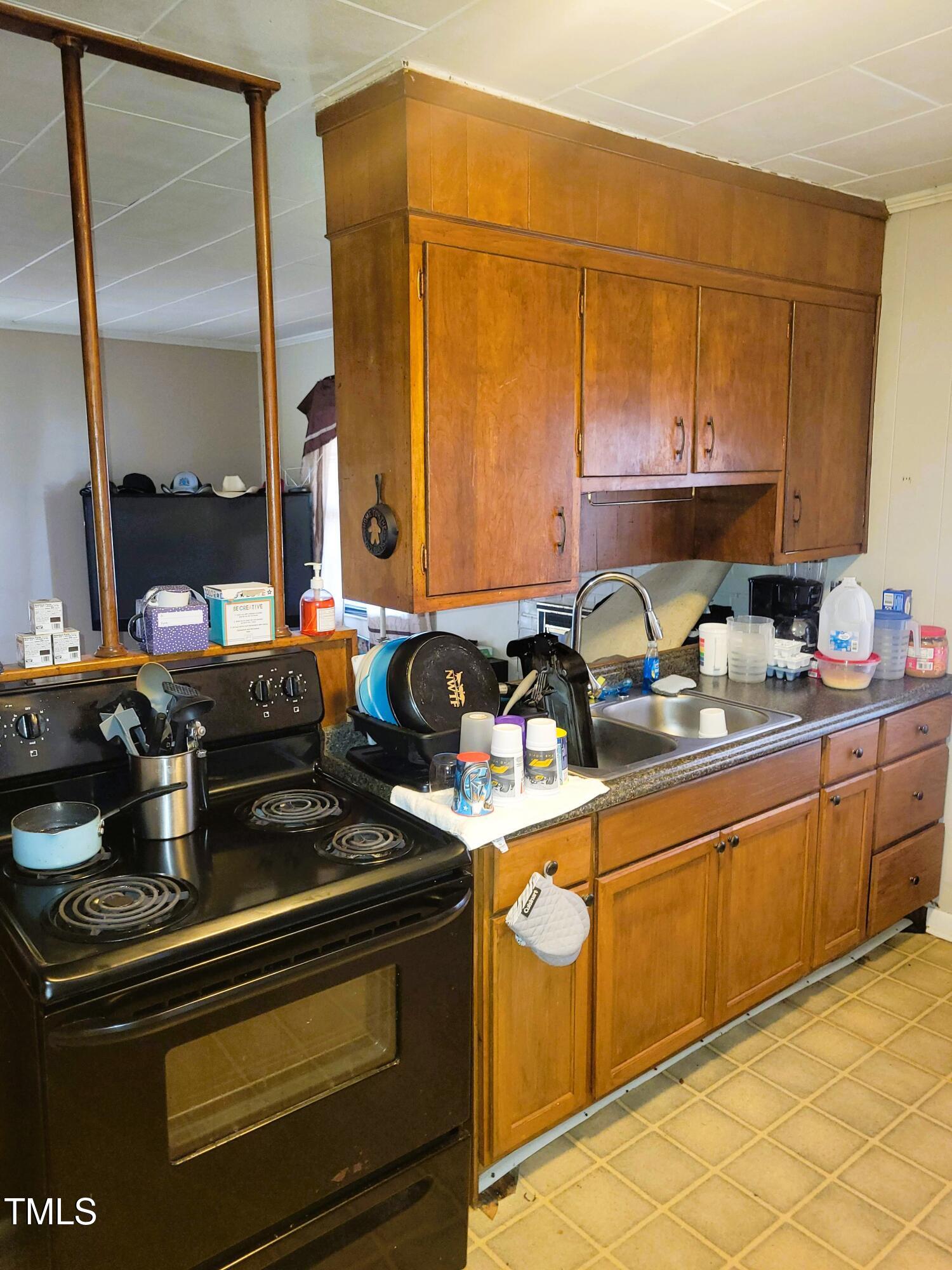 411 West Raleigh Street Siler City, NC 27344 - Photo 21 of 33 a kitchen with stainless steel appliances granite countertop a stove and a sink