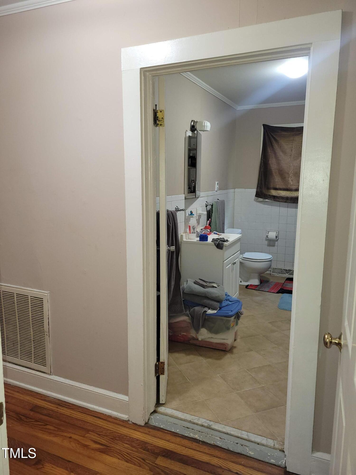 411 West Raleigh Street Siler City, NC 27344 - Photo 23 of 33 a living room with furniture and a wooden floor