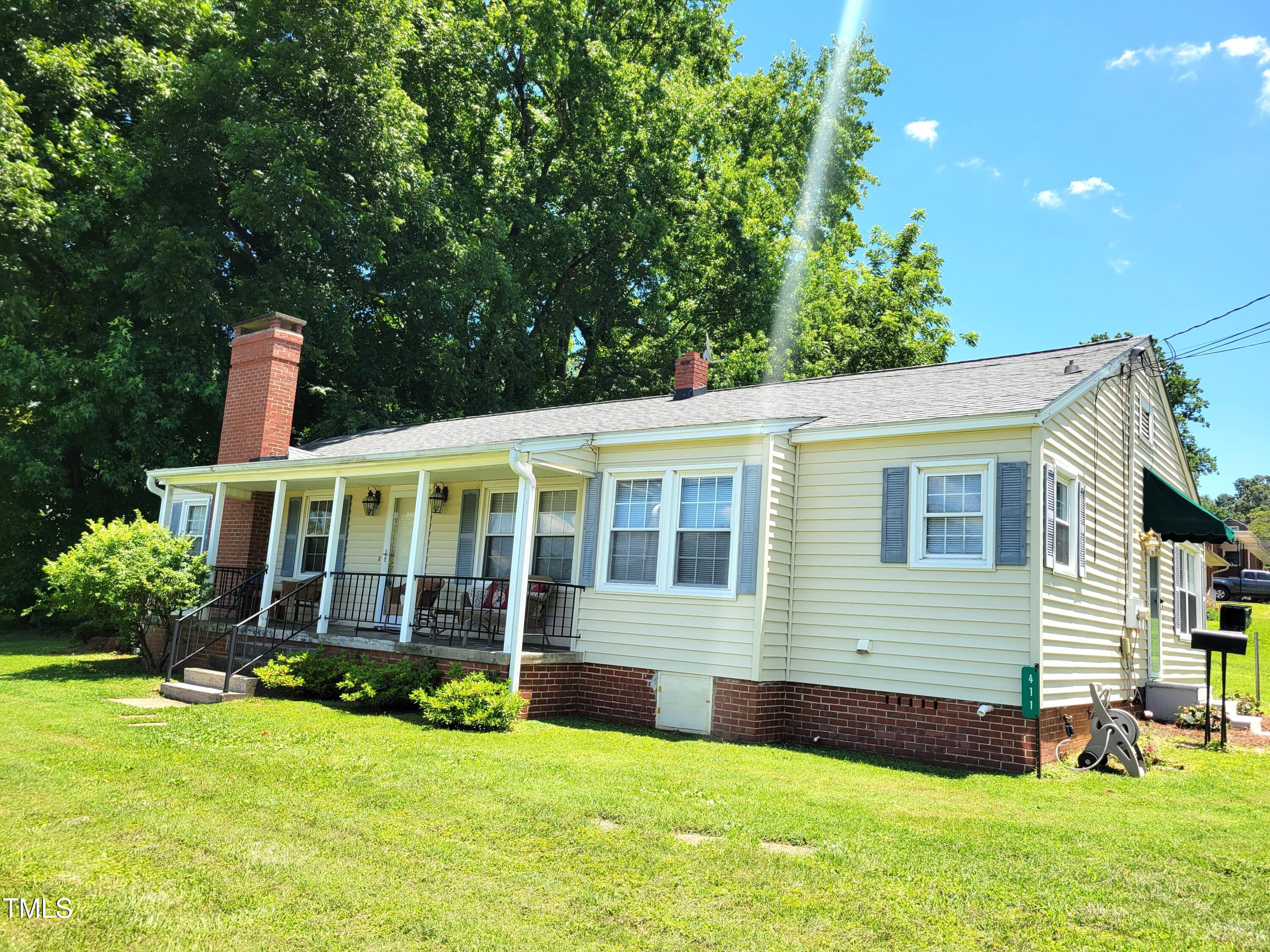 411 West Raleigh Street Siler City, NC 27344 - Photo 26 of 33 a view of a house with a backyard