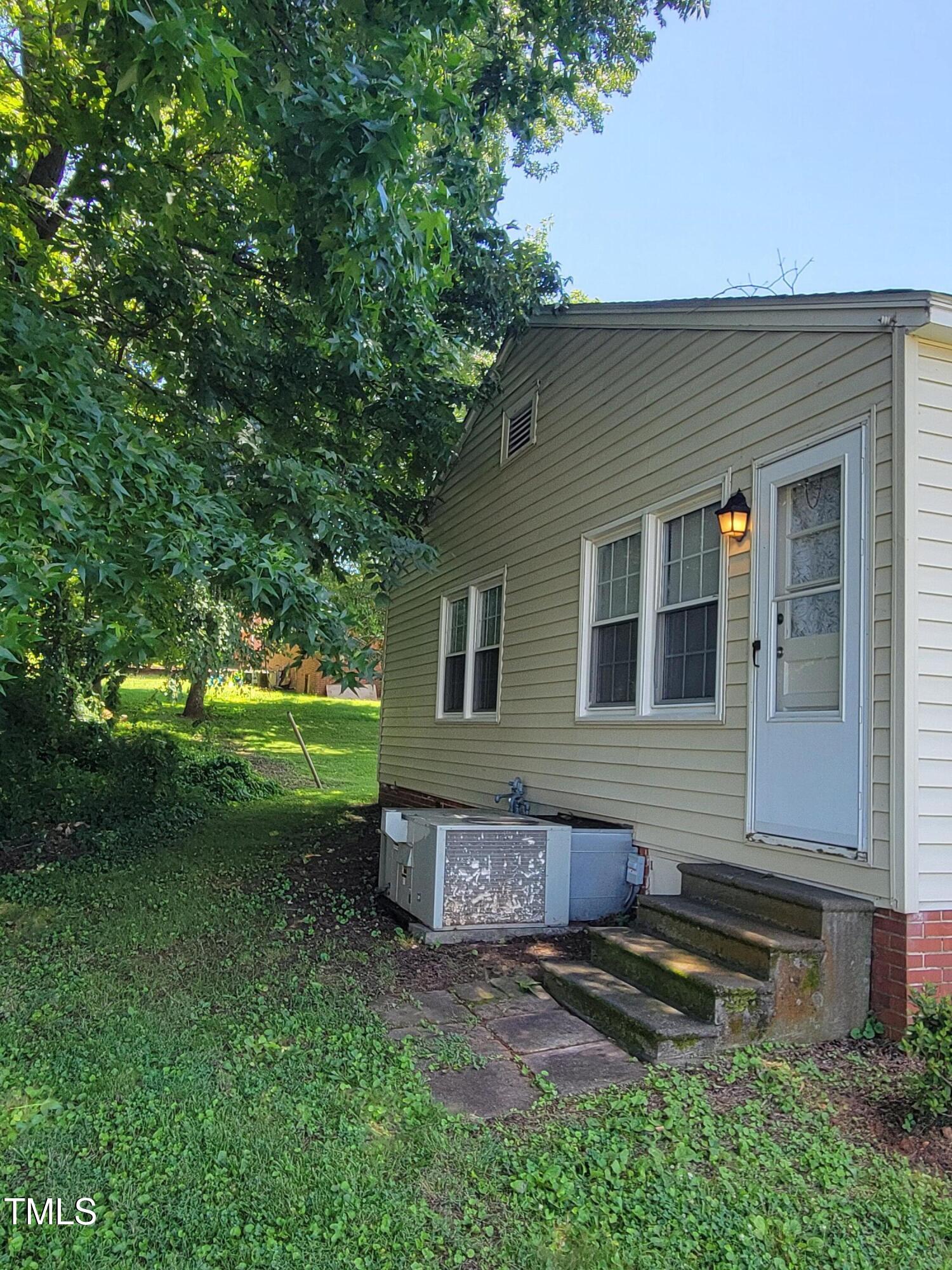 411 West Raleigh Street Siler City, NC 27344 - Photo 27 of 33 a front view of a house with a garden