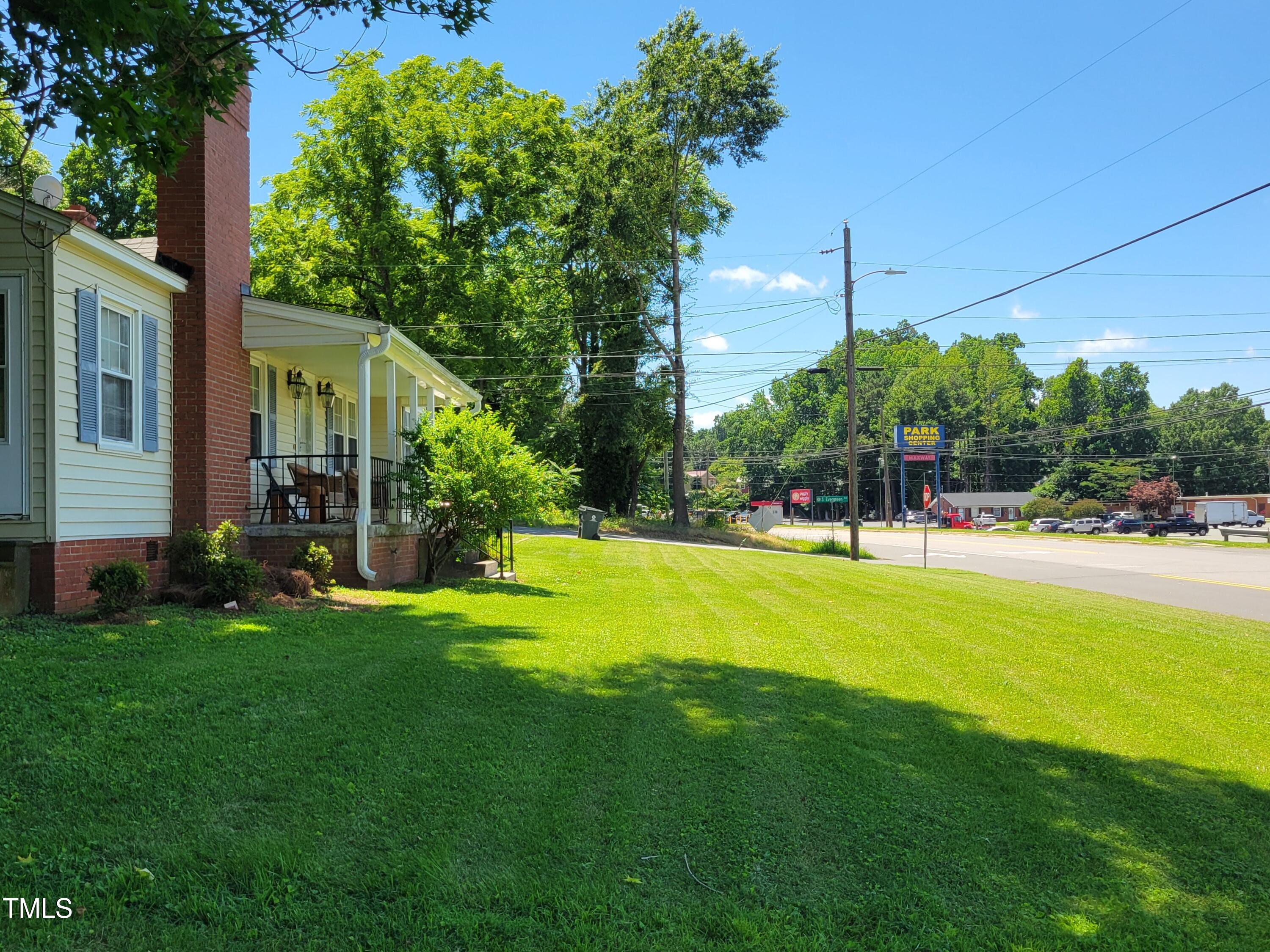 411 West Raleigh Street Siler City, NC 27344 - Photo 29 of 33 a view of a house with a big yard and palm trees