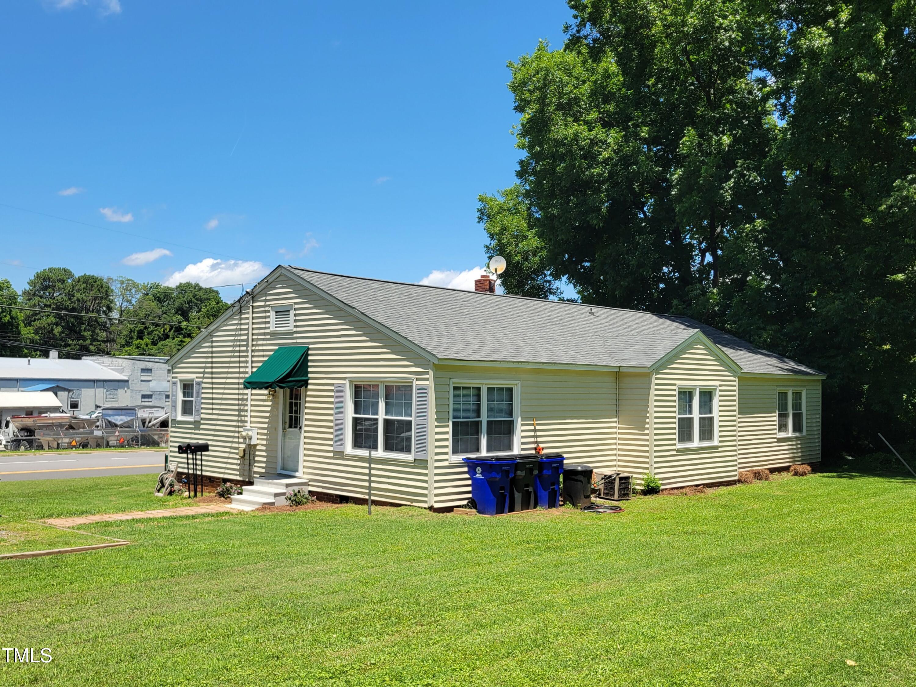411 West Raleigh Street Siler City, NC 27344 - Photo 5 of 33 a view of a house with a backyard