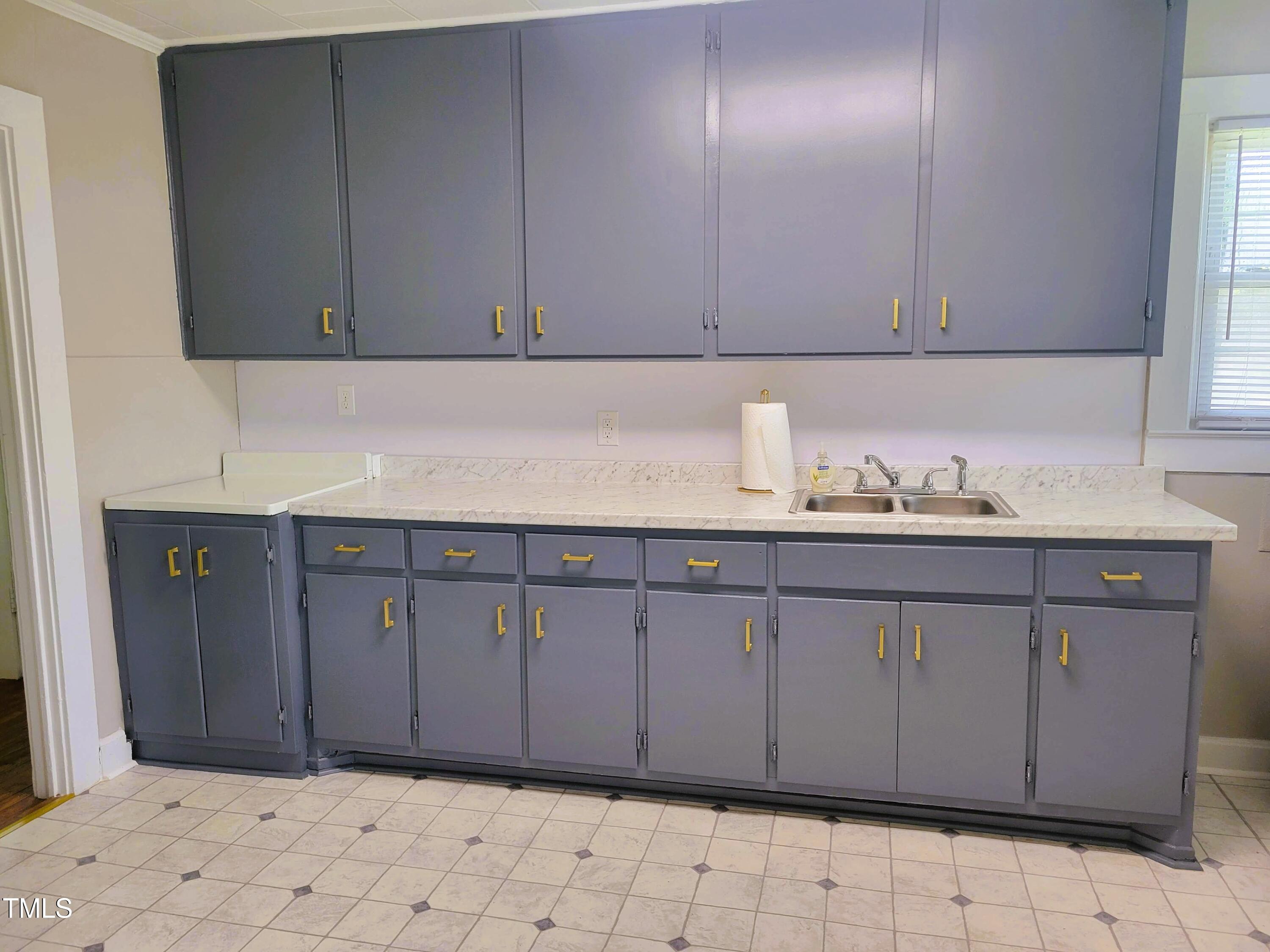 411 West Raleigh Street Siler City, NC 27344 - Photo 7 of 33 a bathroom with a sink and cabinets