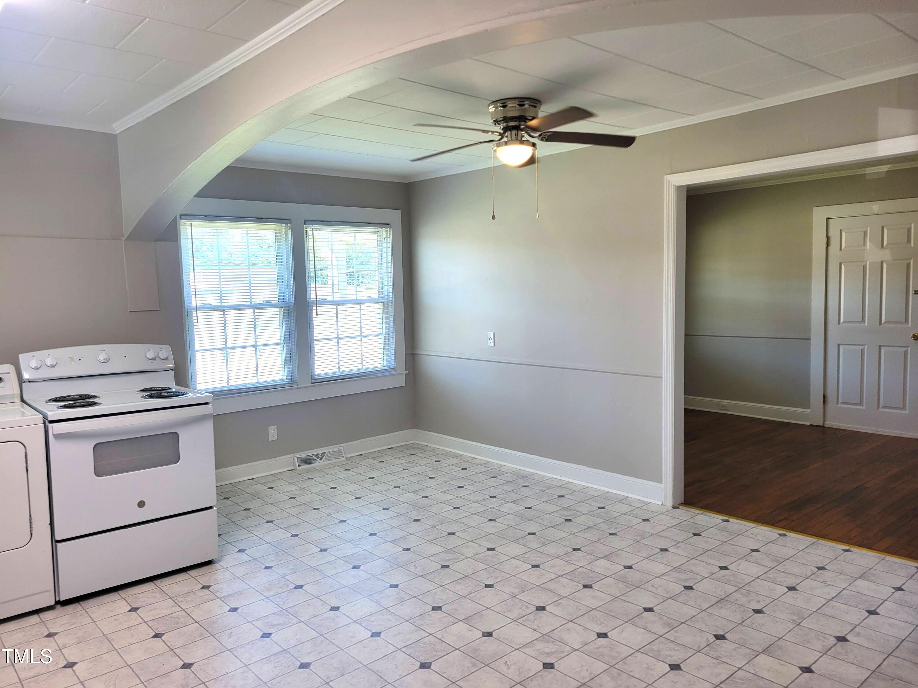411 West Raleigh Street Siler City, NC 27344 - Photo 9 of 33 a kitchen with a stove a sink and a refrigerator