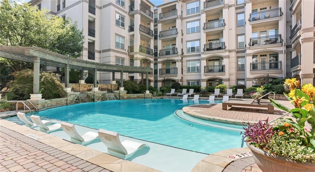 a front view of a building with fountain and outdoor seating